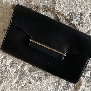 Kelly & Katie black handbag with gold tone chain.